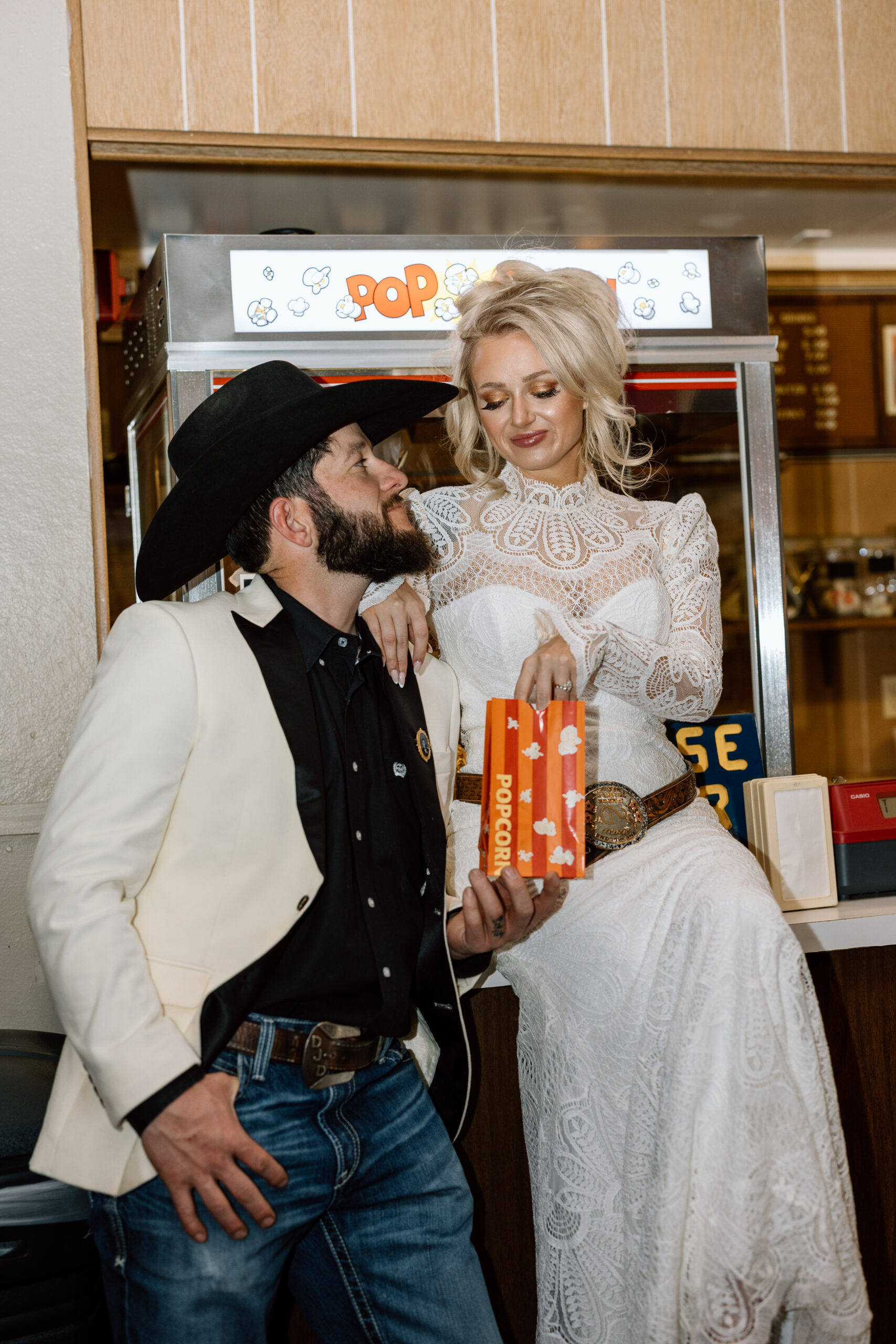 Bride and groom at the historic Luna Theater marquee in Clayton, New Mexico.