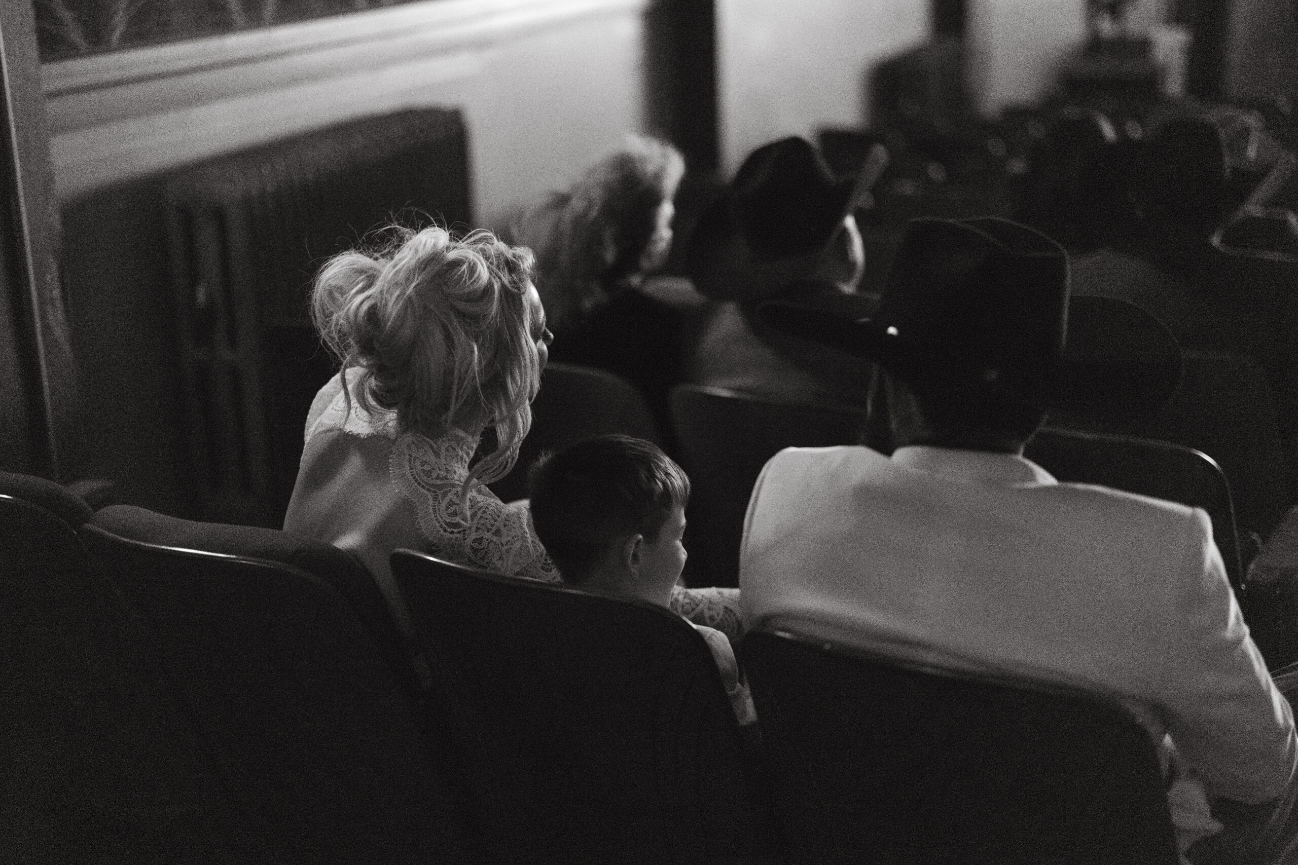 Couple watching their wedding film at the historic Luna Theater after a Palo Duro elopement.