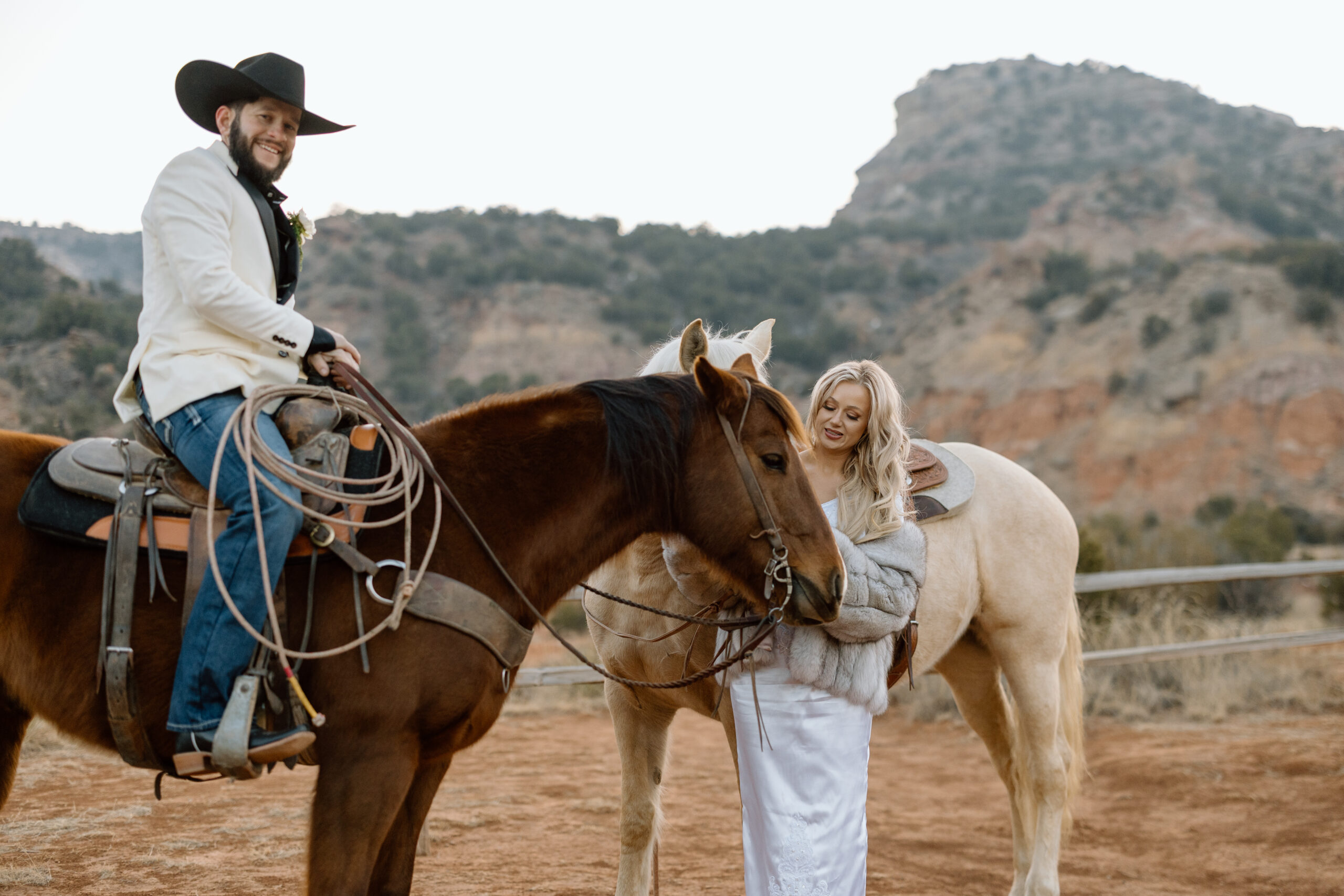Western elopement couple with horses in Palo Duro Canyon for an adventurous Texas wedding.