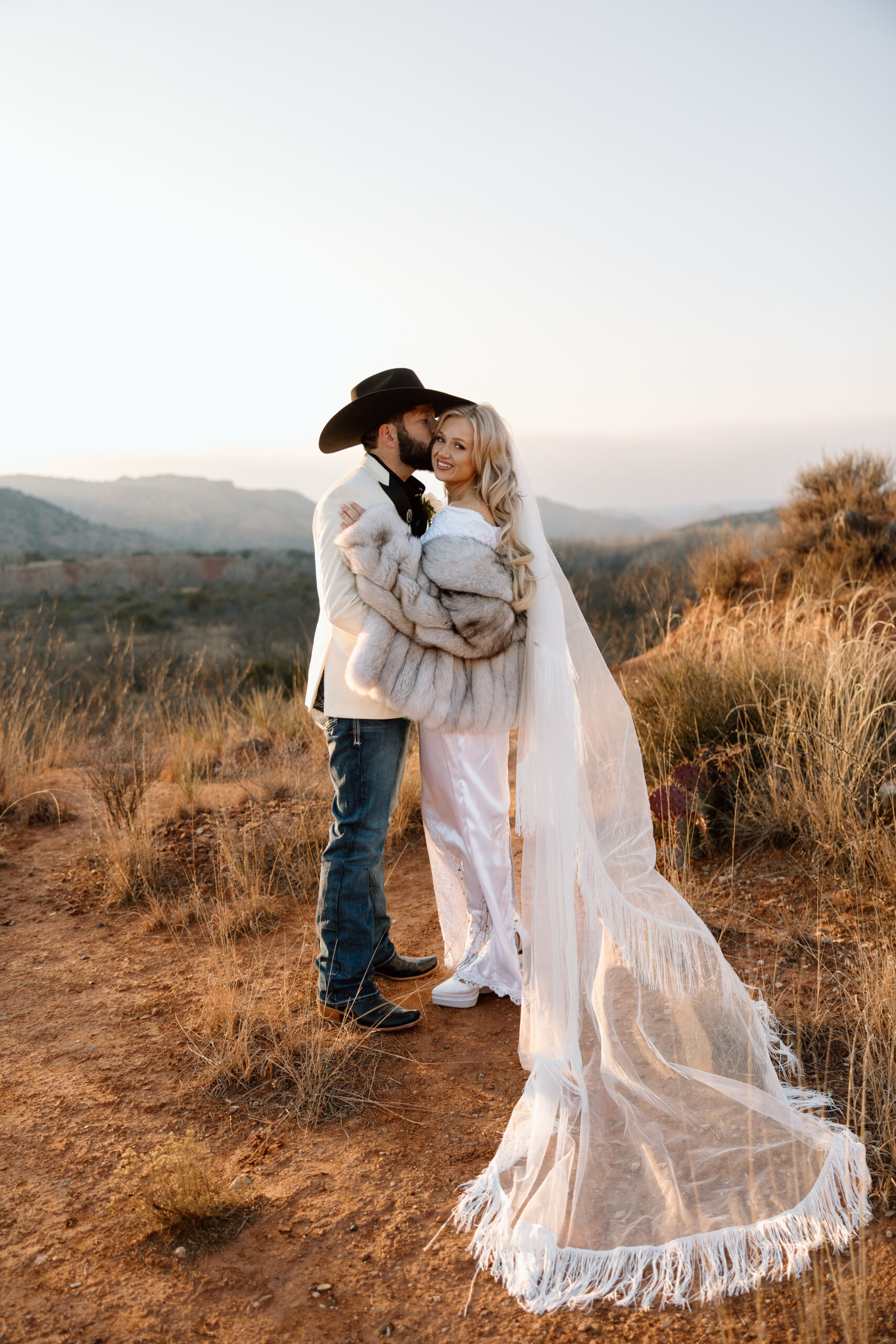 Romantic sunset elopement photo of a couple in the desert landscape of Palo Duro Canyon, Texas.