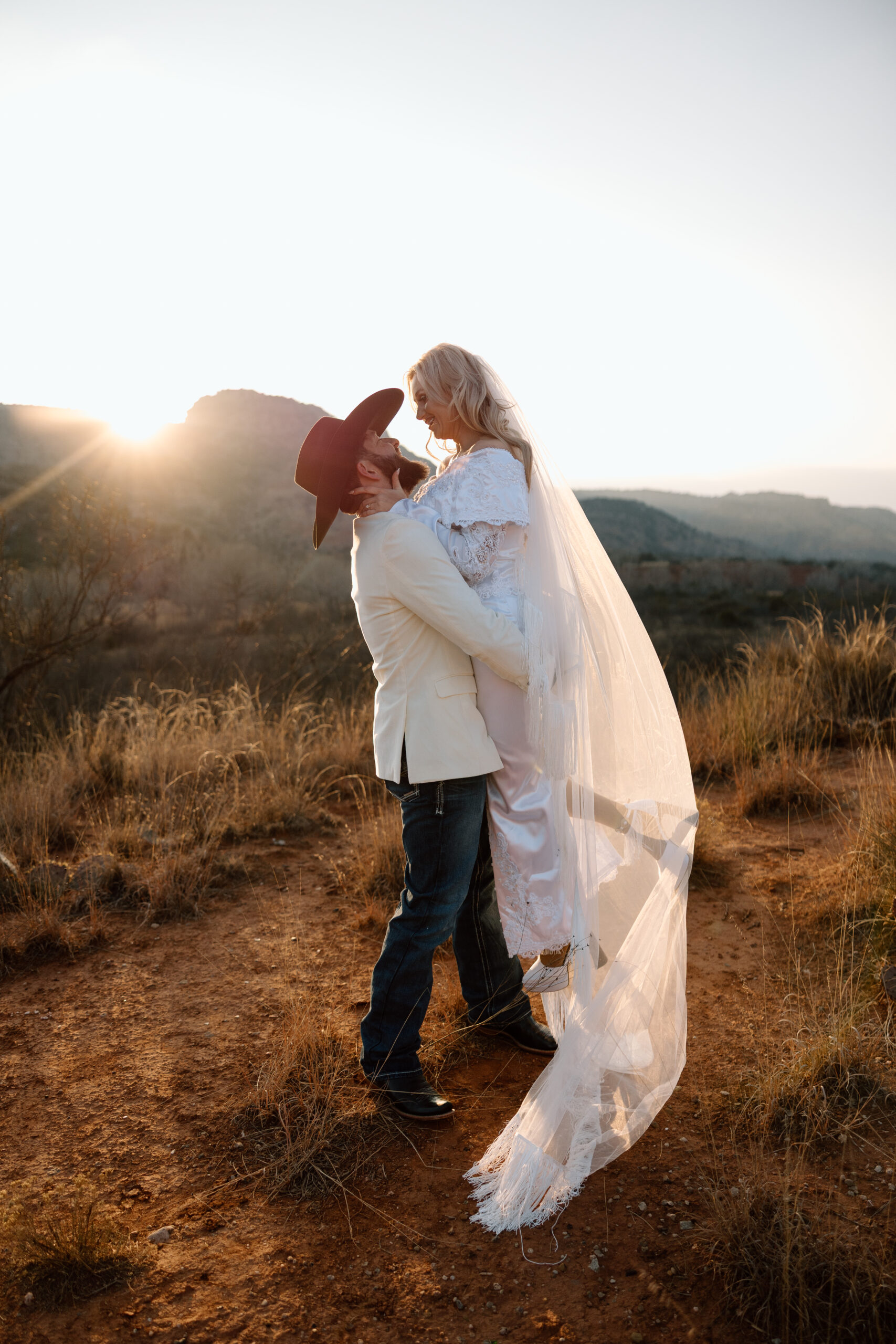 Romantic sunset elopement photo of a couple in the desert landscape of Palo Duro Canyon, Texas.
