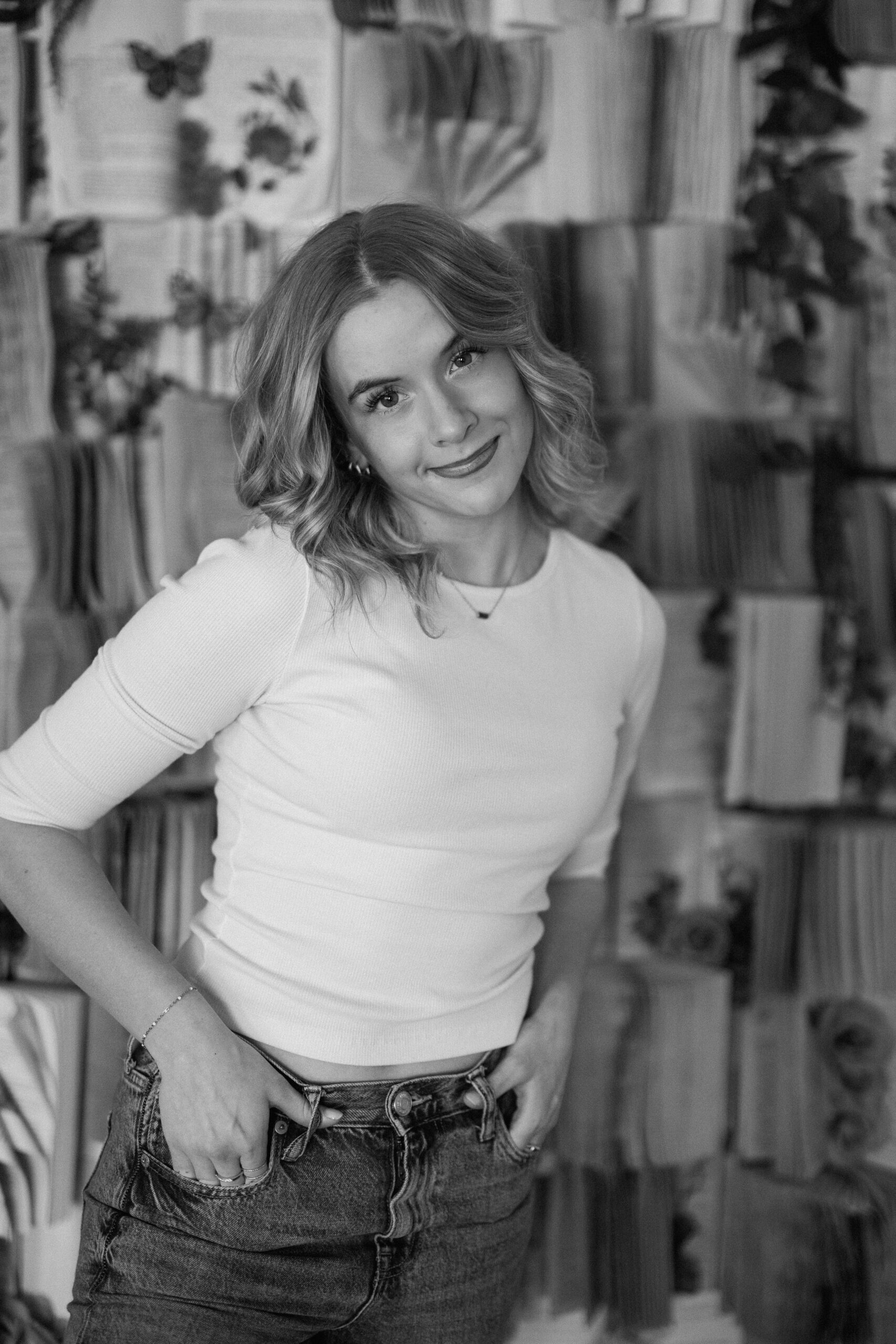 Studio senior portraits in Canyon, Texas, with a book wall.