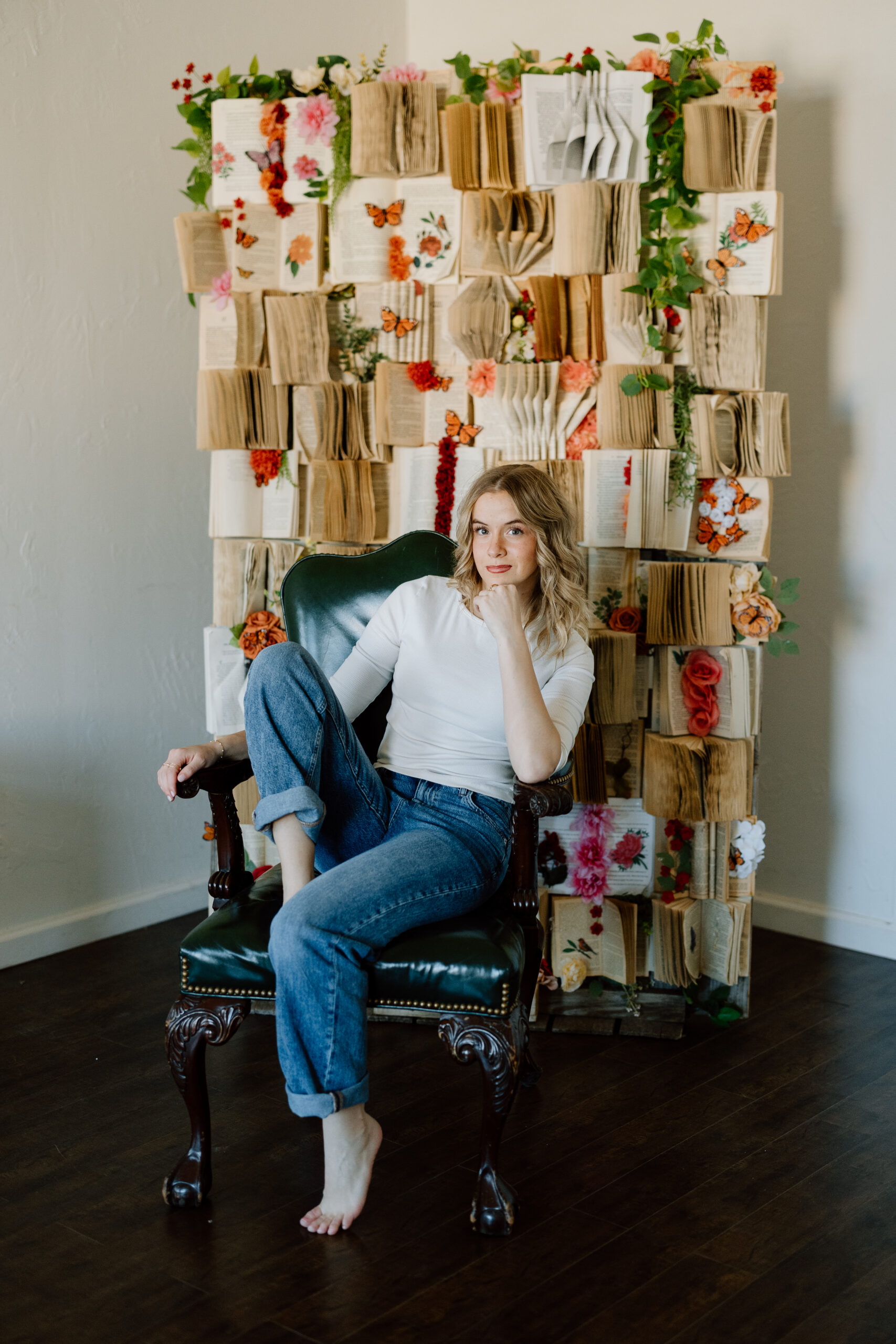 Studio senior portraits in Canyon, Texas, with a book wall.