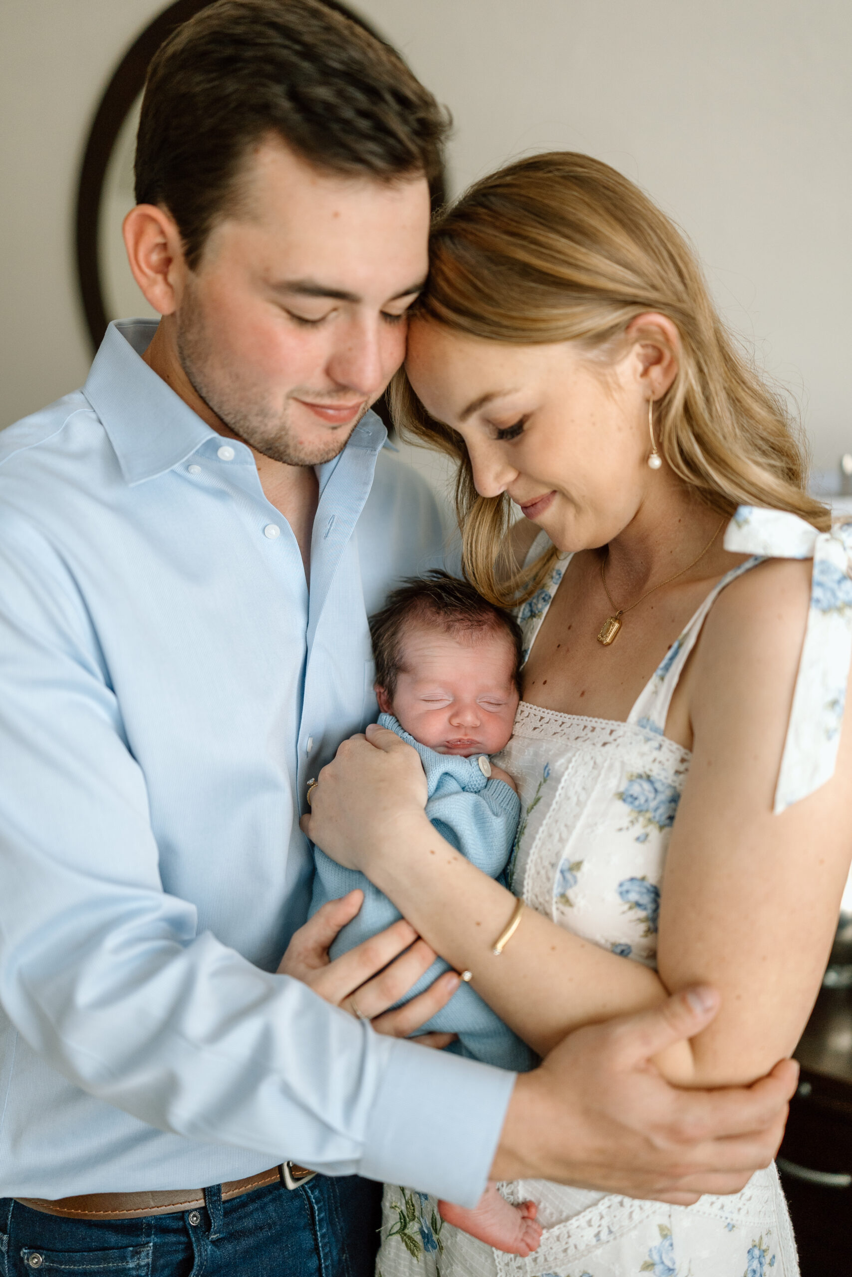 Lifestyle newborn photography tips for using natural window light in a master bedroom.