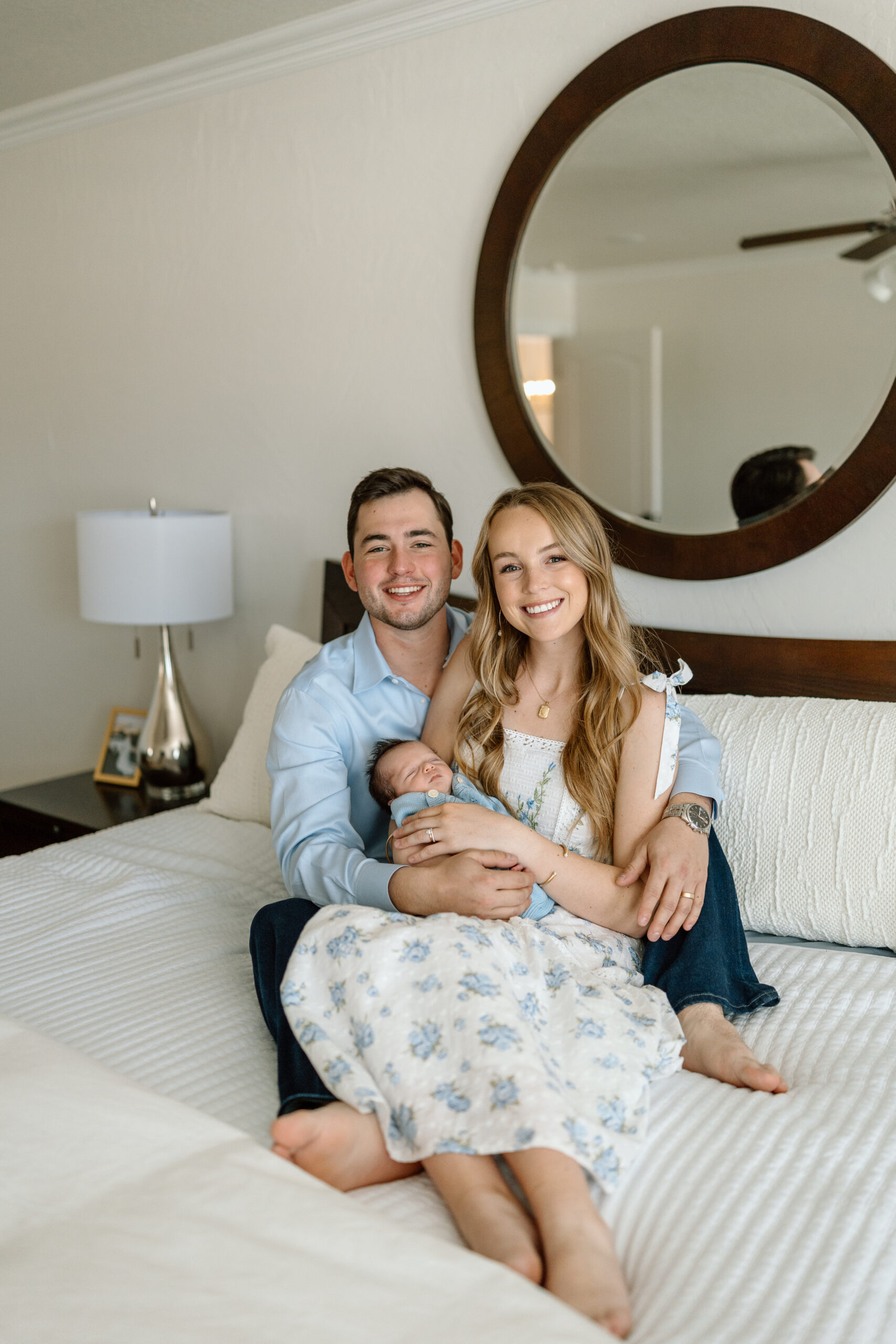Lifestyle newborn photography tips for using natural window light in a master bedroom.