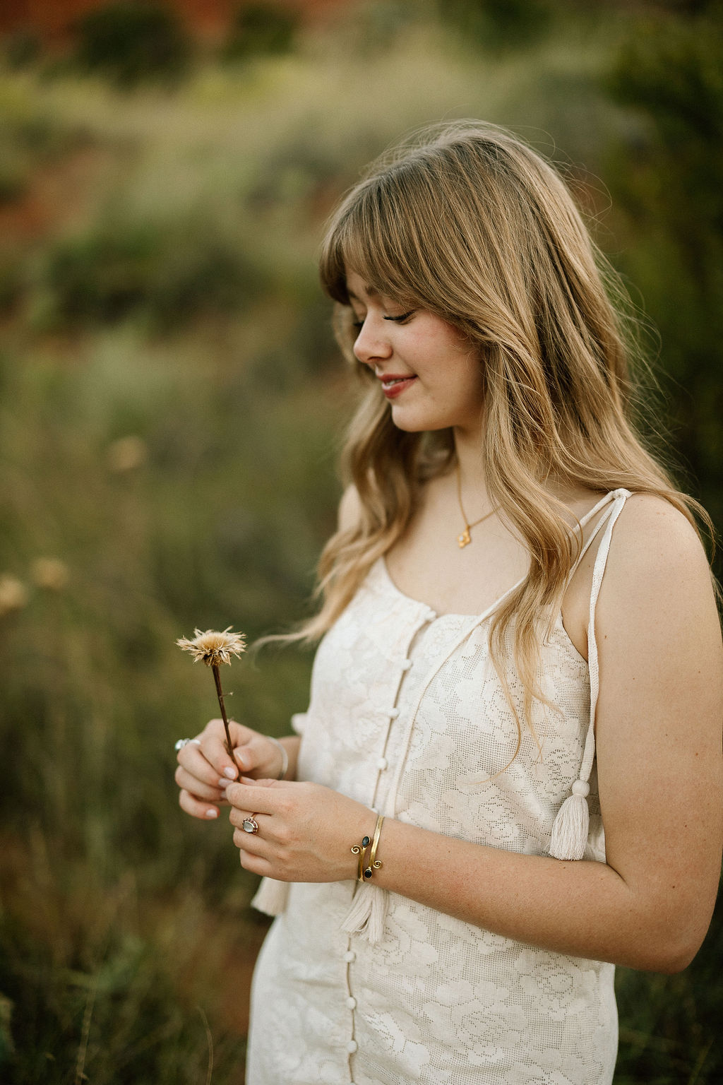 Warm and natural Texas Panhandle senior portraits during golden hour in a grassy field, featuring soft lighting and authentic expressions.