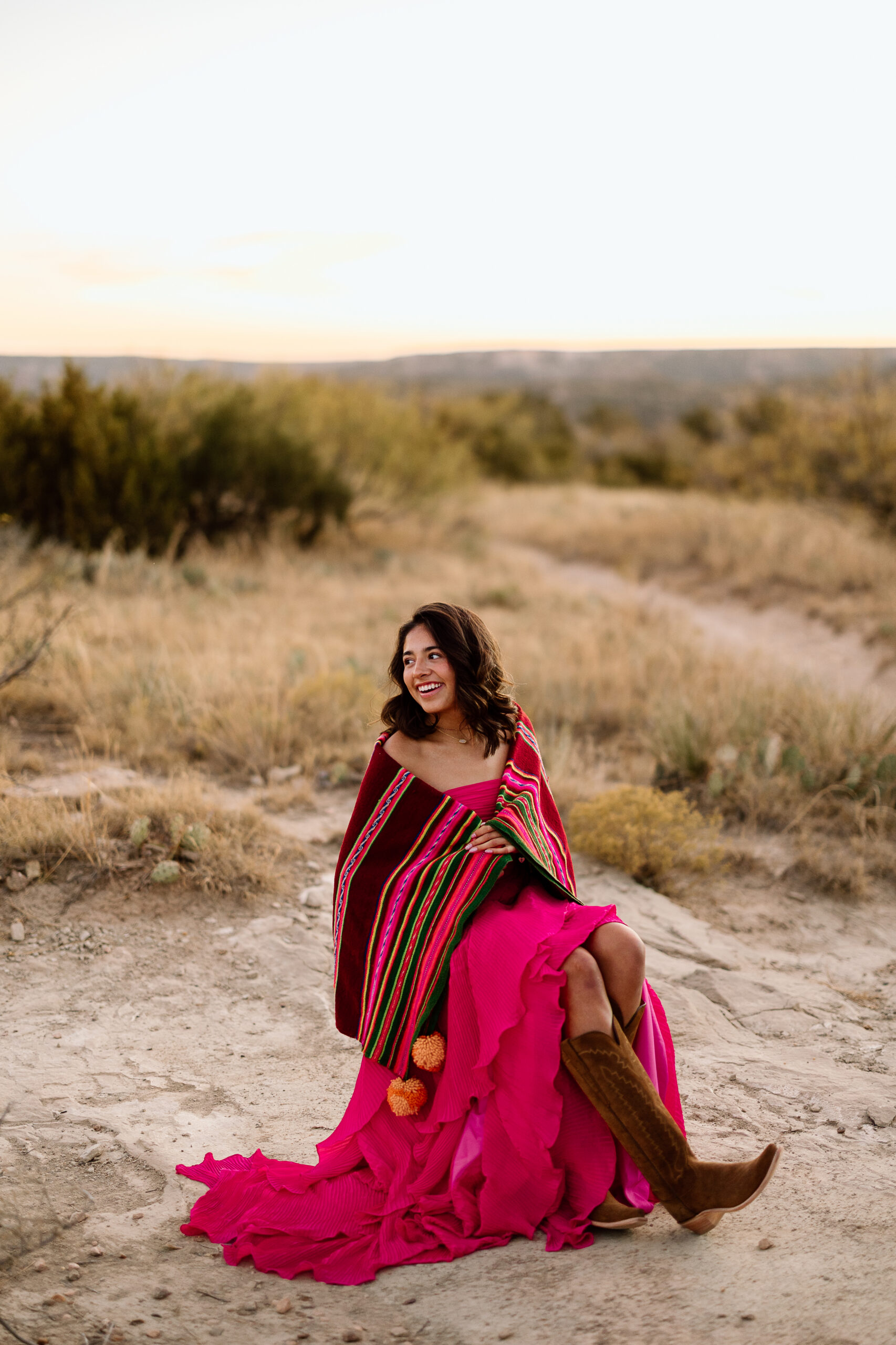 Texas Panhandle senior portraits in boots at Palo Duro Canyon with warm lighting
