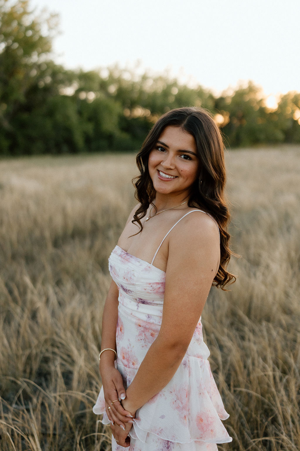 Sun-drenched Texas Panhandle senior portraits in a golden field near Canyon, capturing the warm glow of a West Texas sunset.