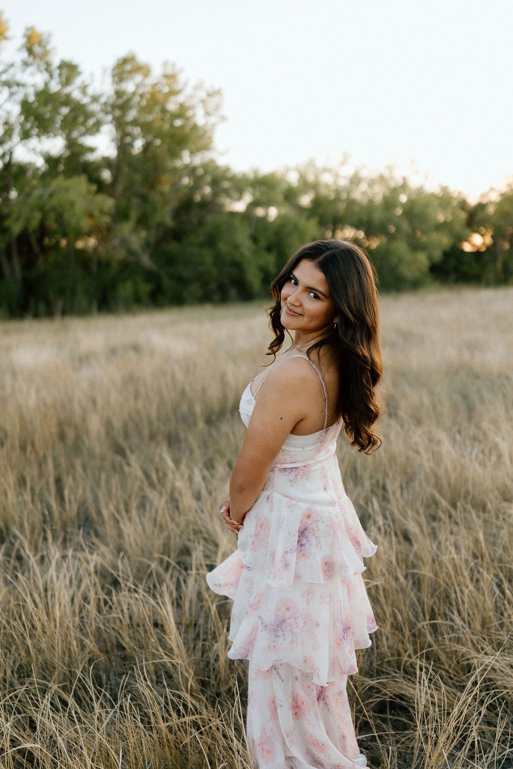 Sun-drenched Texas Panhandle senior portraits in a golden field near Canyon, capturing the warm glow of a West Texas sunset.