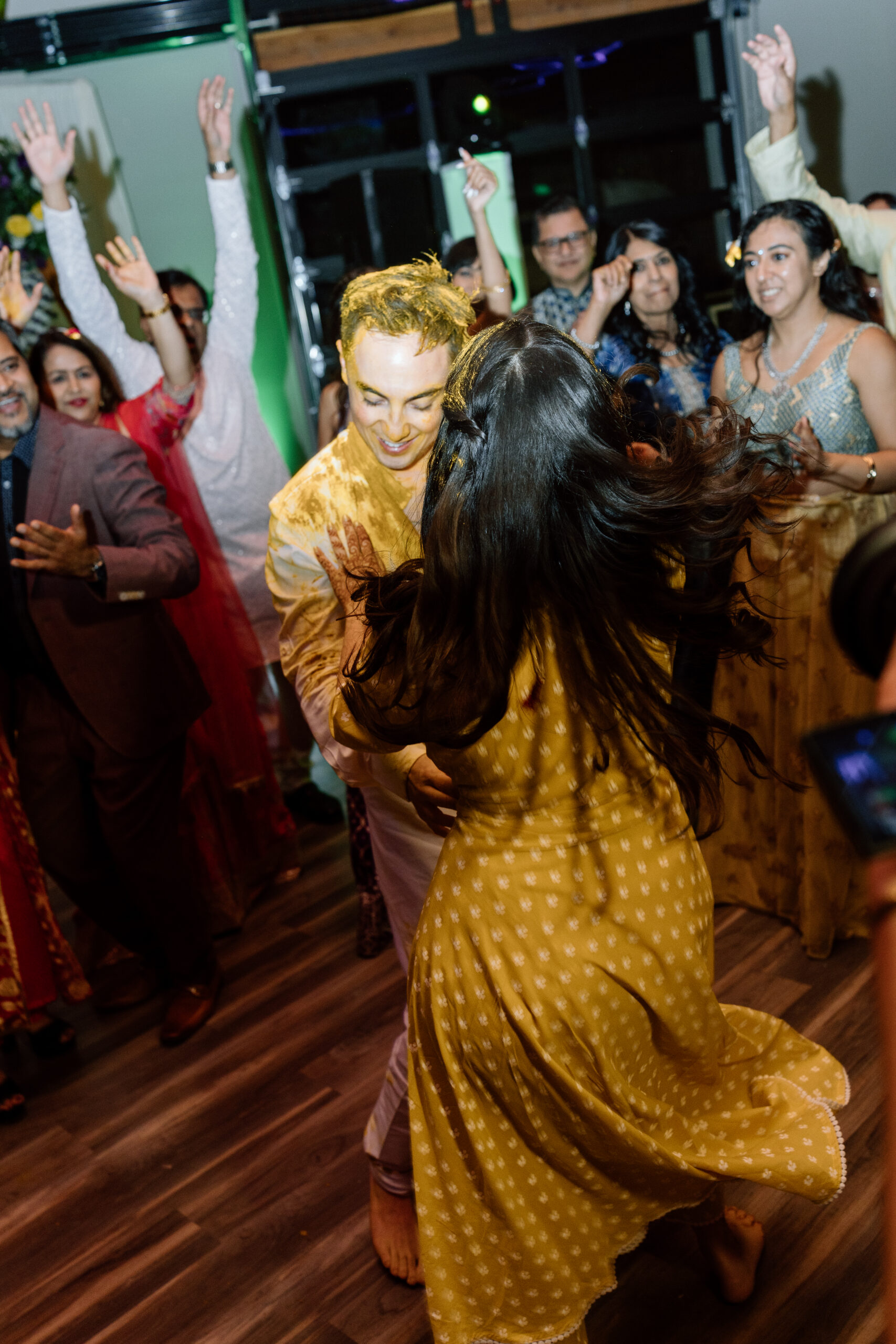 Electric, high-motion dance floor photography using ambient light at a Colorado wedding.