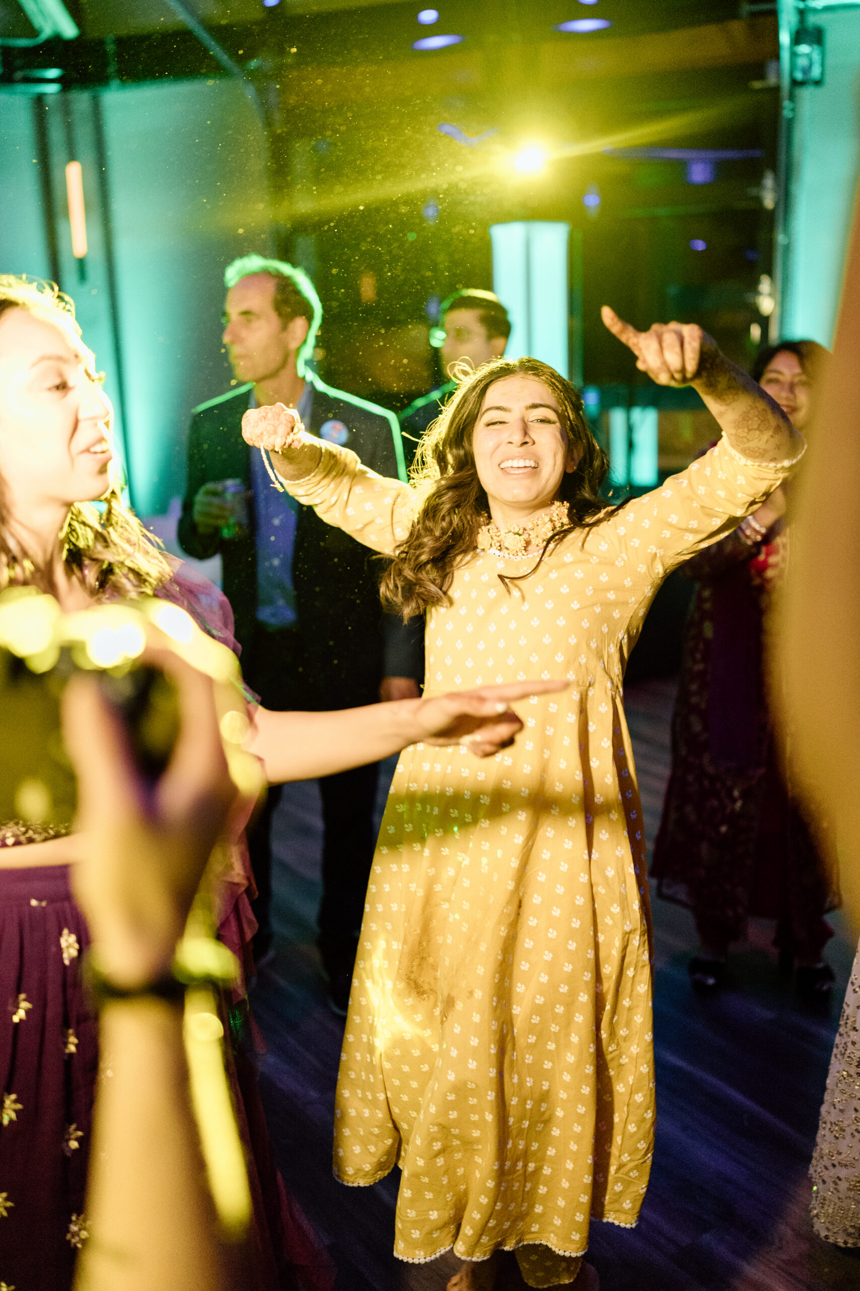 Electric, high-motion dance floor photography using ambient light at a Colorado wedding.