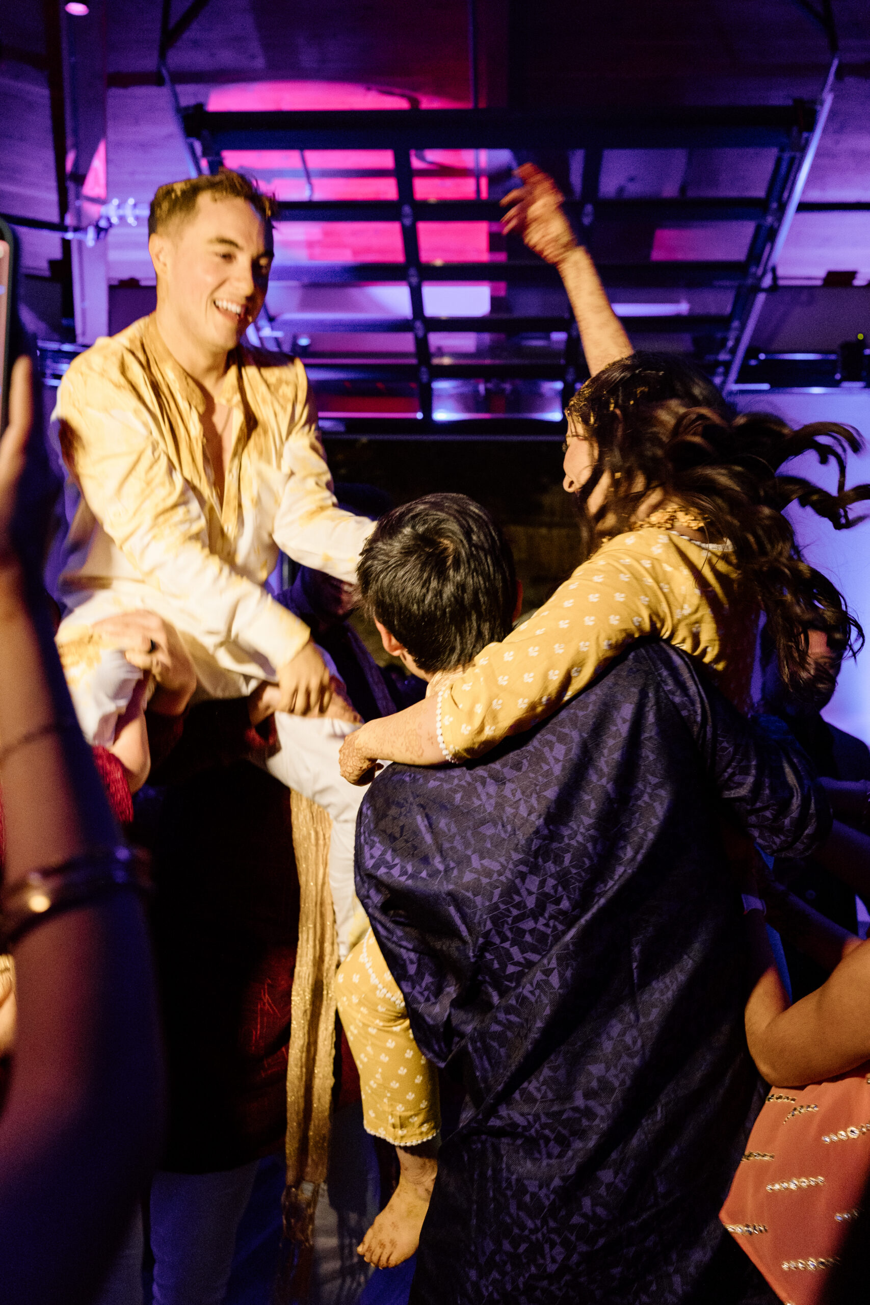 Electric, high-motion dance floor photography using ambient light at a Colorado wedding.