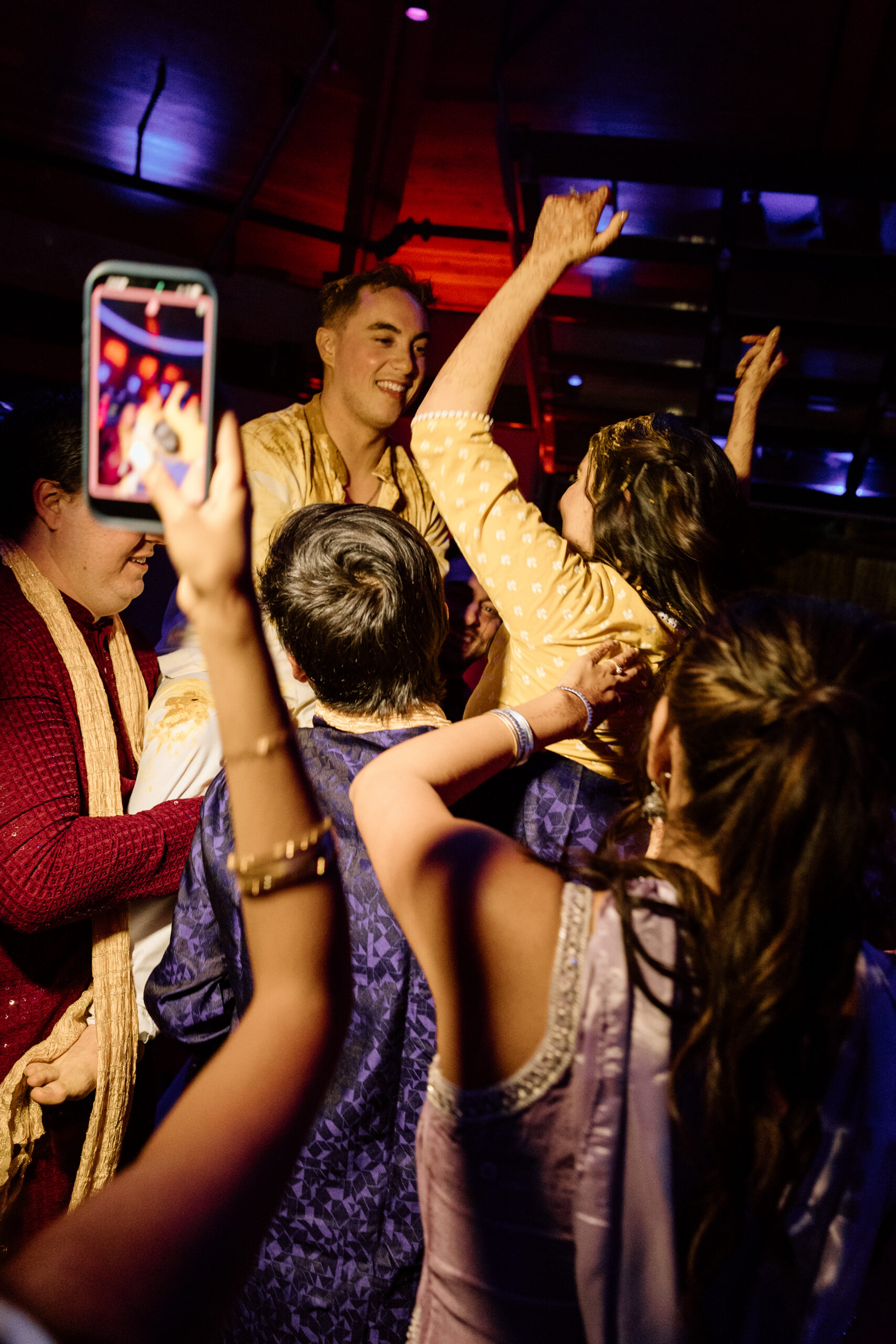 Electric, high-motion dance floor photography using ambient light at a Colorado wedding.