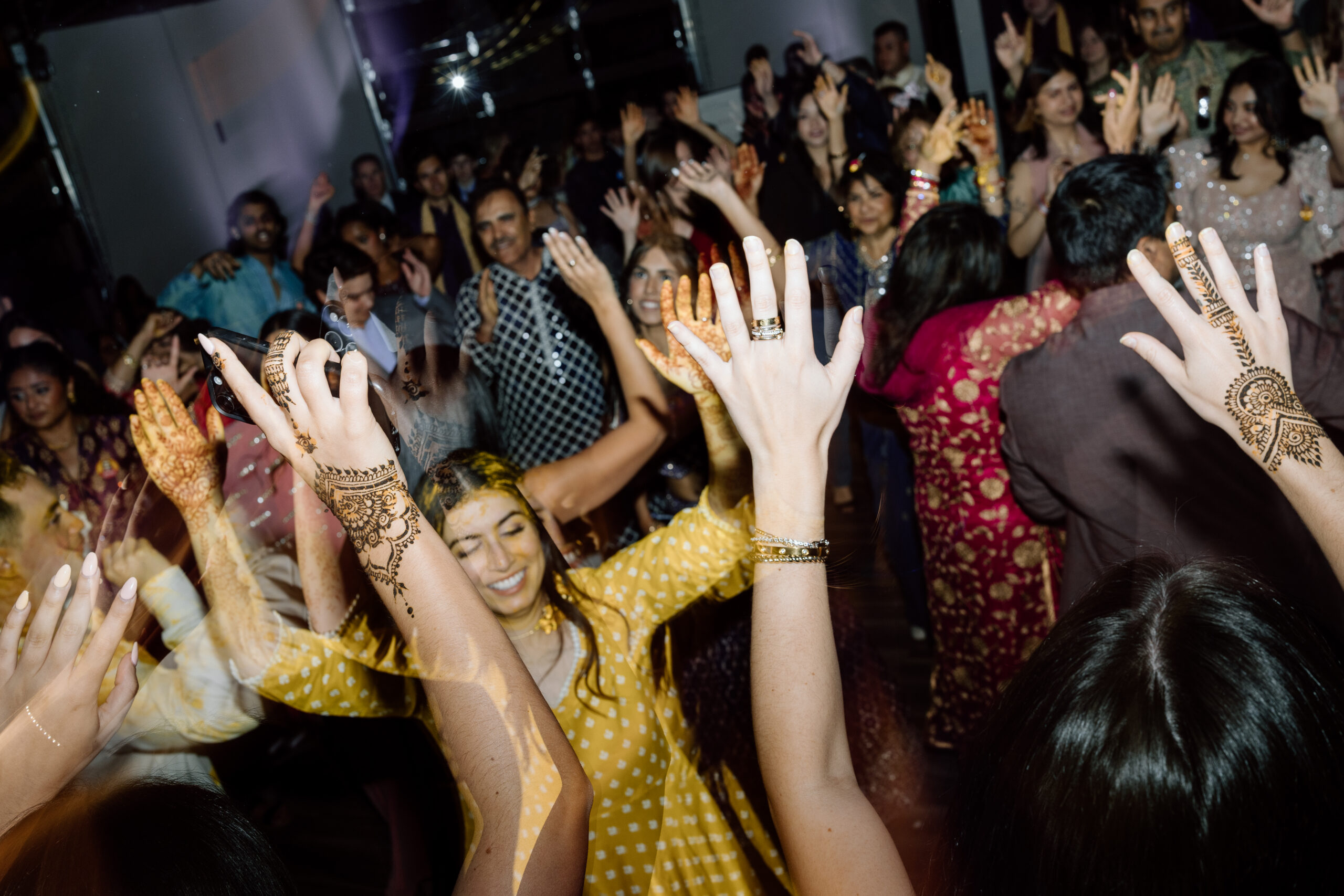 Electric, high-motion dance floor photography using ambient light at a Colorado wedding.