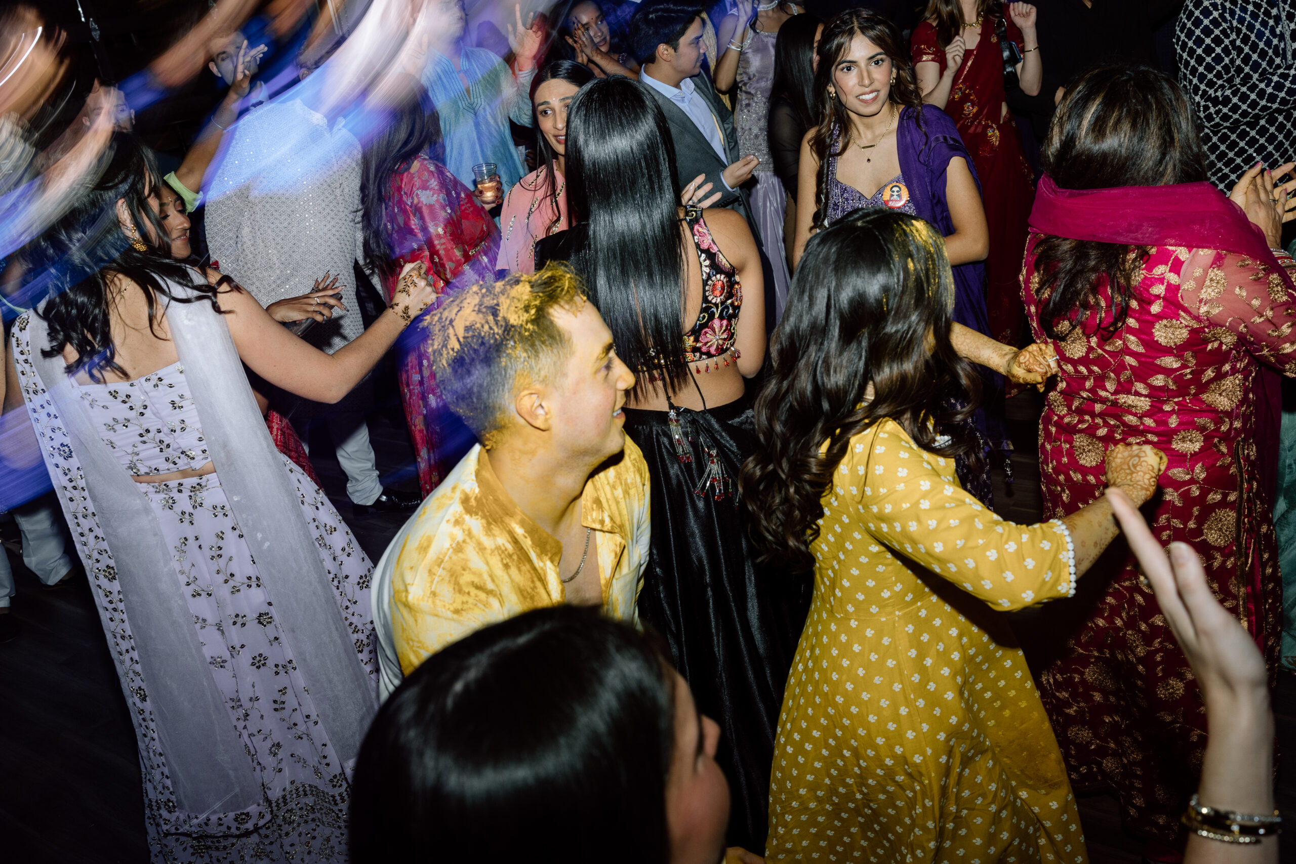 Electric, high-motion dance floor photography using ambient light at a Colorado wedding.