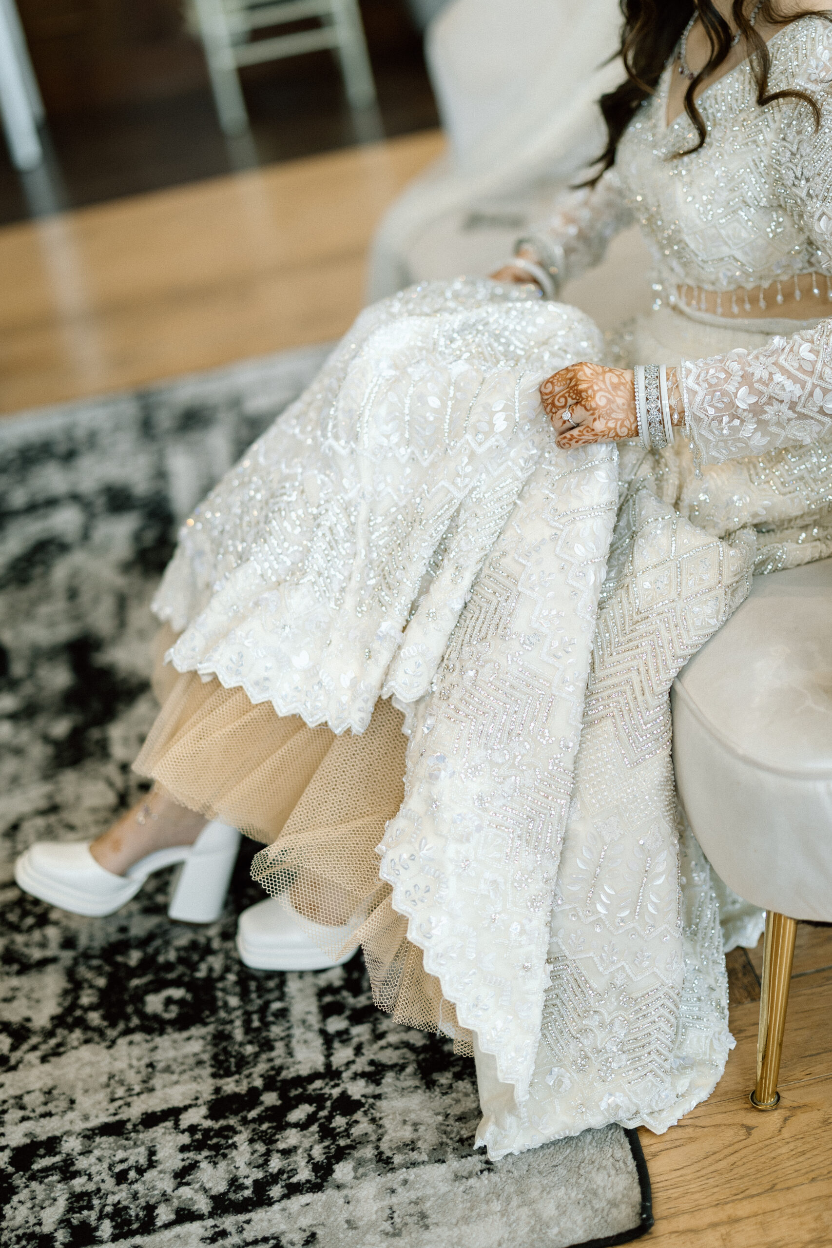 Sparkling wedding jewelry and champagne gown details.