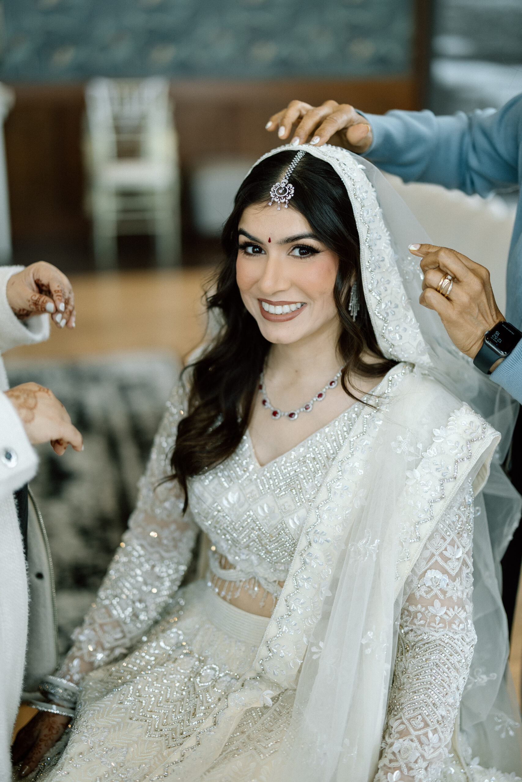 Sparkling wedding jewelry and champagne gown details.