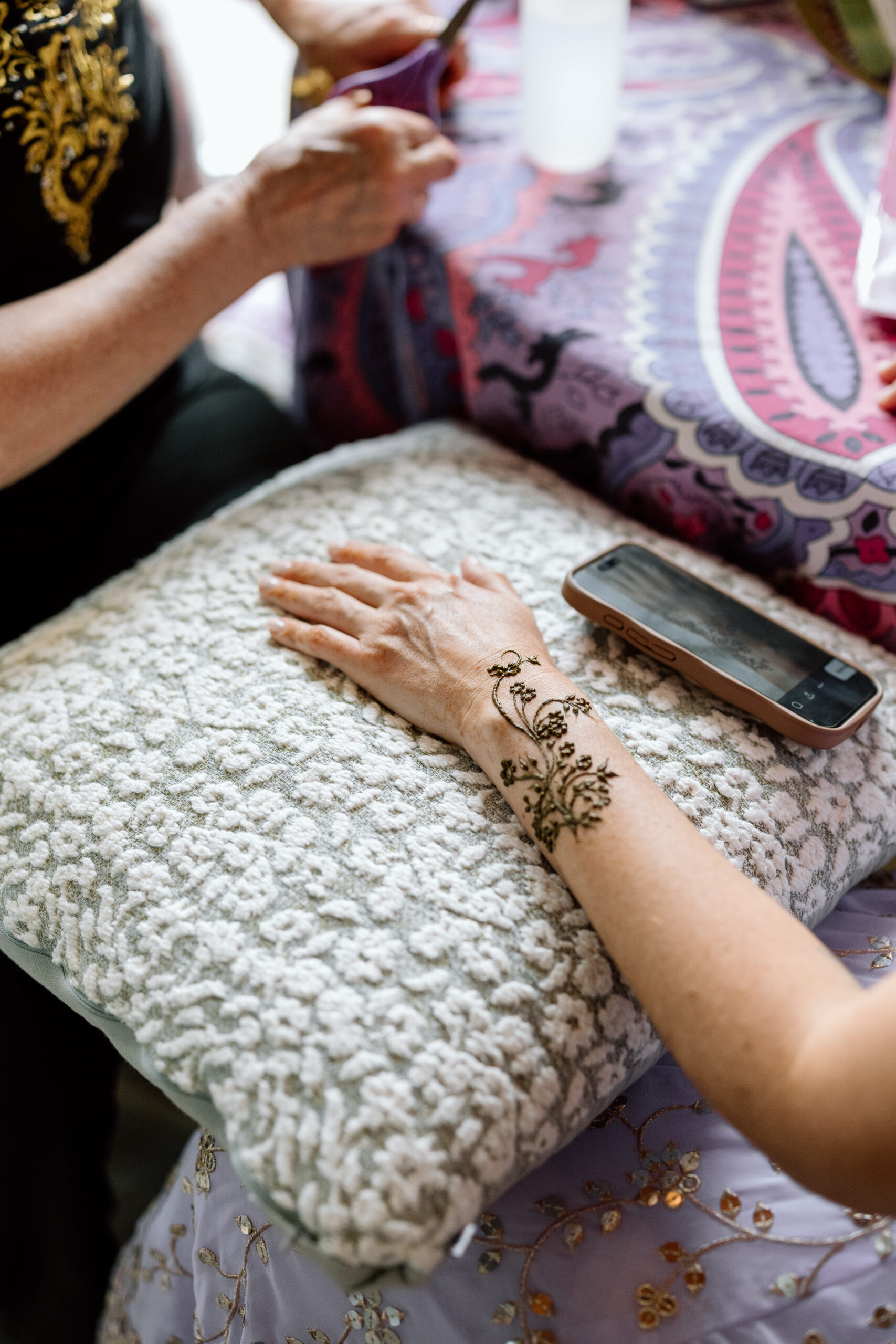 Intricate henna tattoo designs on a bride's hands at a Denver Indian wedding.