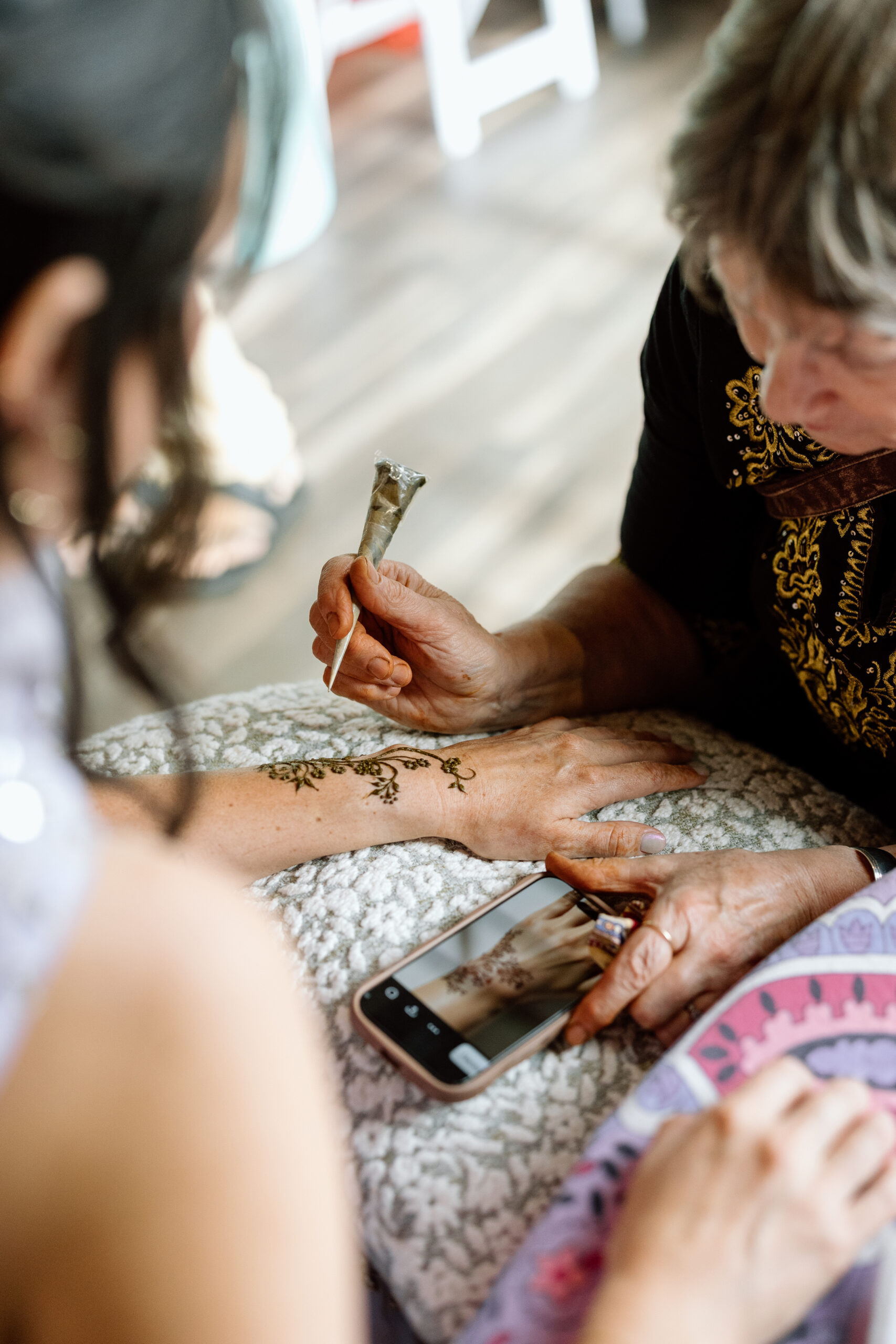 Intricate henna tattoo designs on a bride's hands at a Denver Indian wedding.