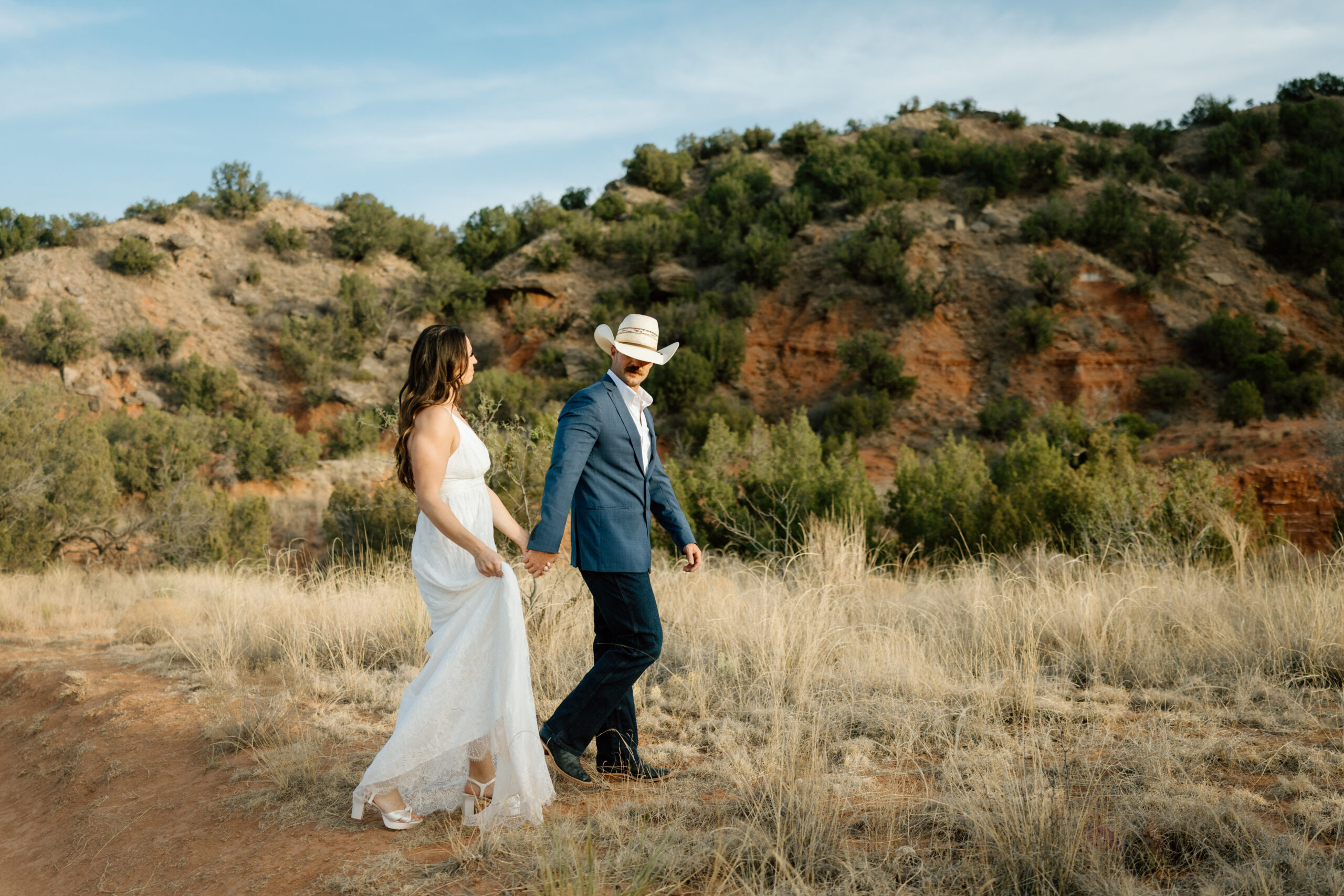 Candid wedding photography in Palo Duro Canyon with dramatic red rock backdrop