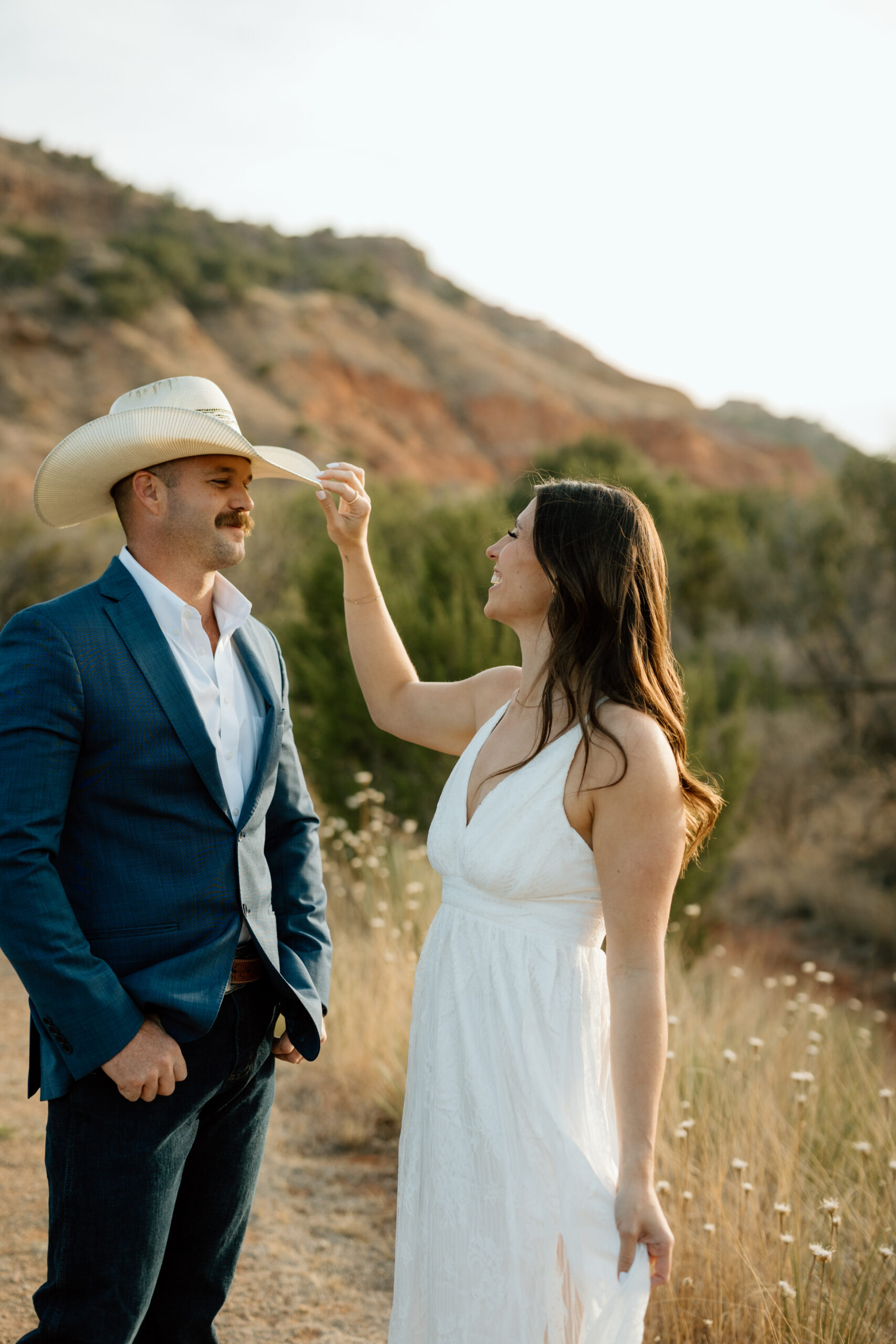Candid wedding photography in Palo Duro Canyon with dramatic red rock backdrop