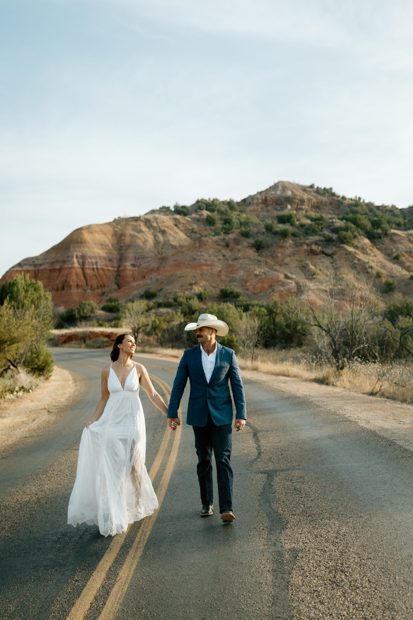 Candid wedding photography in Palo Duro Canyon with dramatic red rock backdrop
