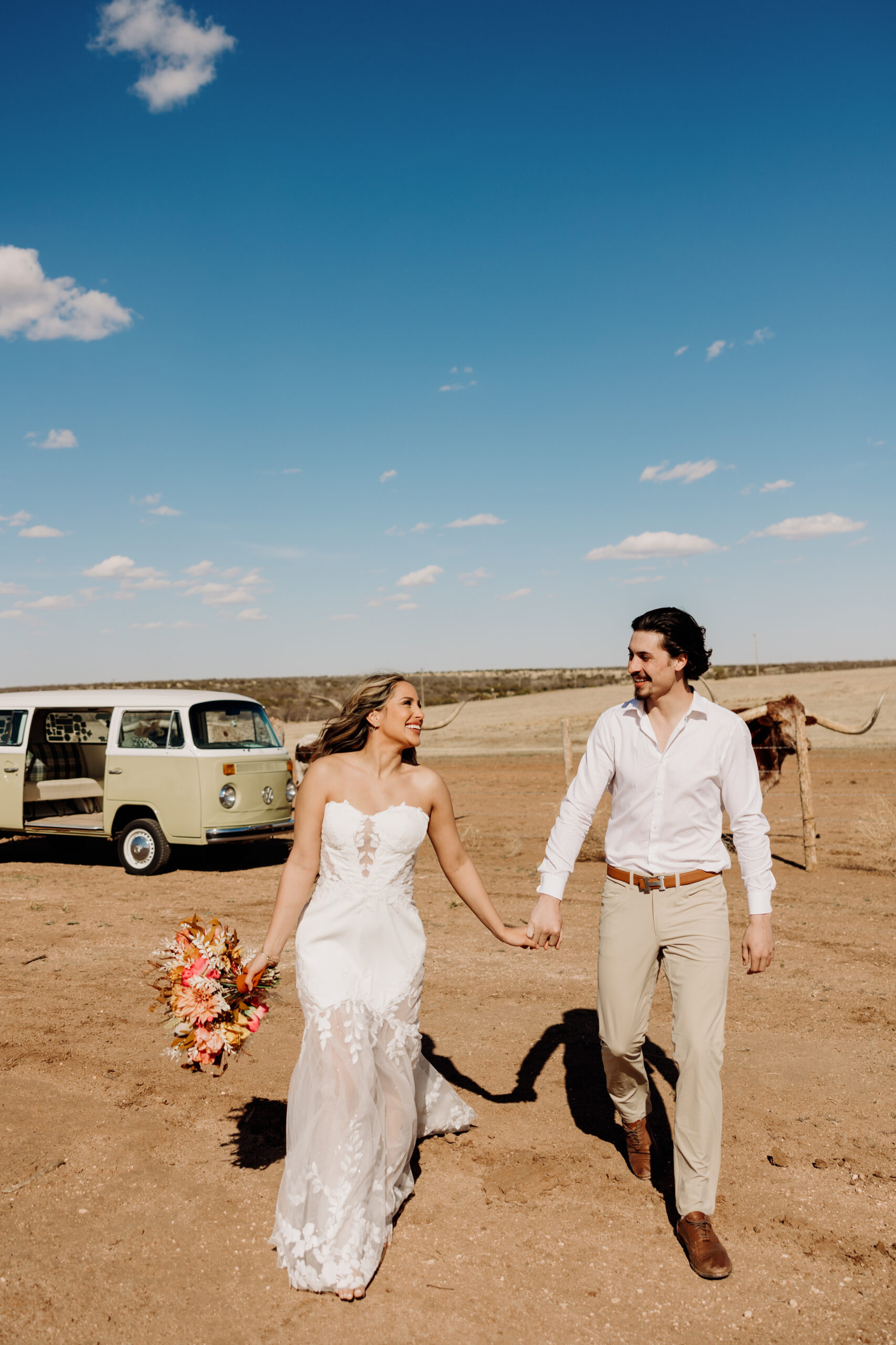 Bride and Groom portraits with Longhorns at Sad Monkey Hall in Canyon TX